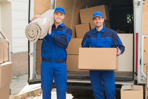 Moving crew with PPE handling furniture safely indoors