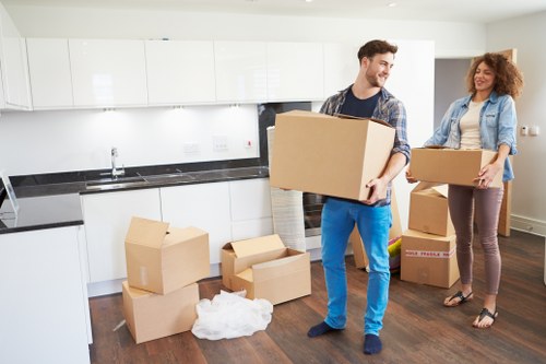 Removalists in Bayswater carefully carrying a sofa through a home