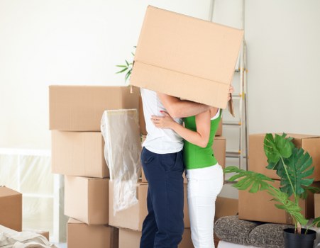 Professional movers handling furniture in a central London apartment building