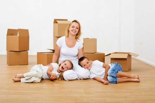 Removal staff using safe lifting techniques for heavy furniture